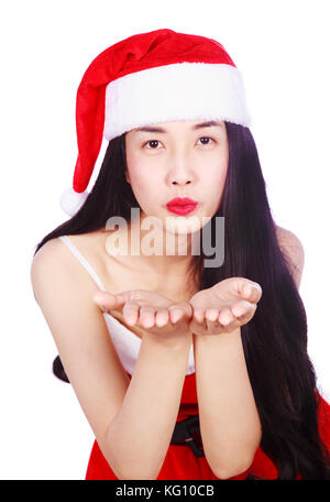 Woman blowing a kiss au père Noël vêtements isolé sur fond blanc Banque D'Images