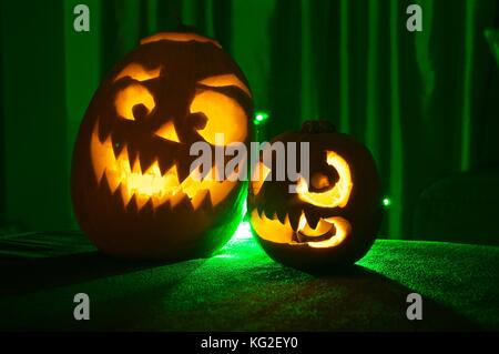 Grandes et petites citrouilles sculptées avec des lumières à l'intérieur et spooky visages Banque D'Images