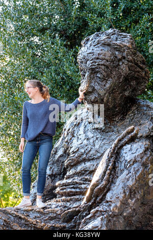 Adolescentes, touristiques, se frottant le nez d'Albert Einstein d'acquérir certaines de ses connaissances, Albert Einsten Memorial, Washington DC, USA. Banque D'Images