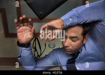 Businessman sleeping on glass table Banque D'Images