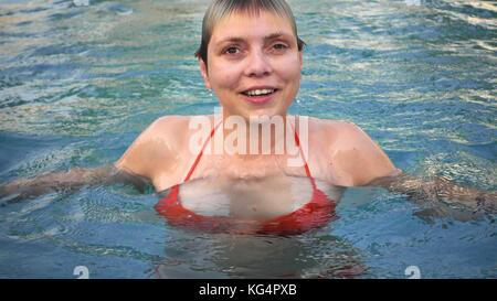 Young woman in red bikini sortant de l'eau Banque D'Images