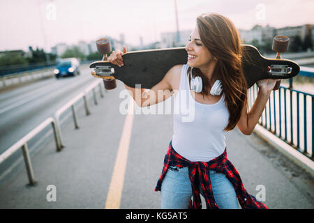 Portrait of beautiful smiling girl skateboard transport