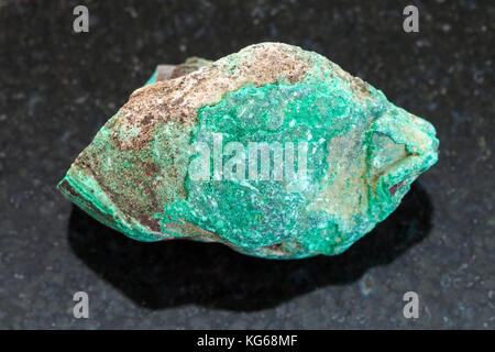 La prise de vue macro des eaux minérales naturelles rock specimen - pierre malachite brute sur fond de granit sombre Banque D'Images