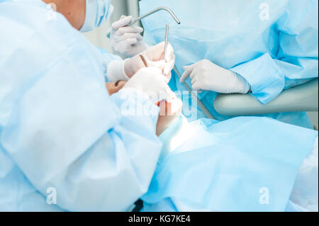 Close up - processus de chirurgie dentaire chirurgien dentiste. implantation avec assistant en clinique moderne. stomatologie et soins de santé concept. focus sélectif. Banque D'Images