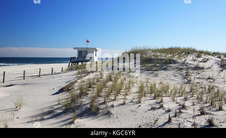 Le drapeau rouge sur le dessus de la garde de la vie abandonné shack, signale la fin d'une longue saison de la plage en été et inaugure l'automne tranquille solitude Banque D'Images