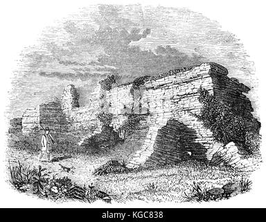 Huntsman et gun-dog en passant l'enceinte fortifiée ruines de Richborough Roman Fort, près de Sandwich, Kent, Angleterre. Rutupiae ou Portus Ritupis a été fondée par les Romains après leur invasion de la Bretagne en 43 AD par l'empereur Claude. Elle est devenue un port Britannique sous les Romains et le point de départ de leur équivalent de Watling Street. Banque D'Images