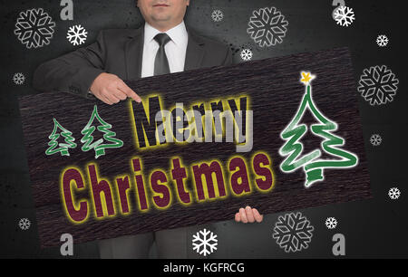 Joyeux noël poster est tenu par l'homme d'affaires. Banque D'Images