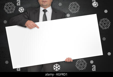 Flocons de concept affiche est tenu par l'homme d'affaires. Banque D'Images