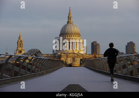 LONDRES, Royaume-Uni - VERS OCT 2017 - une femme court le long du pont du Millénaire, vers la cathédrale Saint-Paul. Banque D'Images