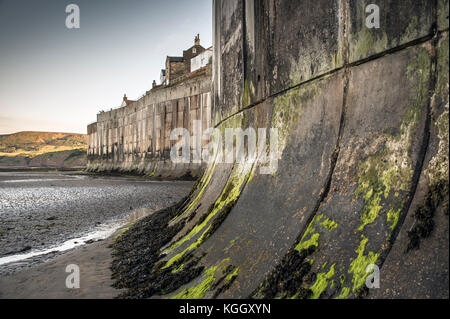 Le mur de la mer à marée basse, Robin Hood's Bay, dans le Yorkshire. Banque D'Images