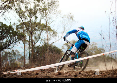 Photo horizontale avec espace pour protéger de l'enduro en équitation de vélo de montagne de descente rapide dans un sentier poussiéreux Banque D'Images