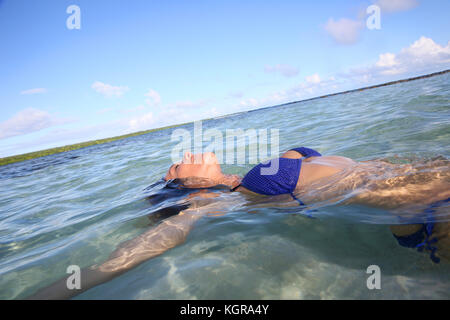 Closeup of woman floating in lagoon Banque D'Images