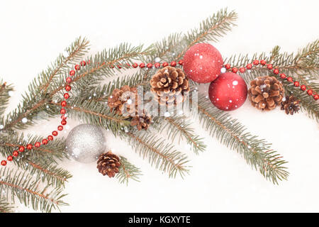 Décoration de Noël avec la direction générale de pin rouge et argent, ballons, cônes et red garland Banque D'Images