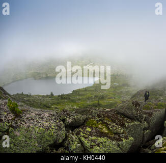 Couple dans la brume sur la passerelle du lac en hiver. L'après-midi paisible. L'air brumeux. Banque D'Images