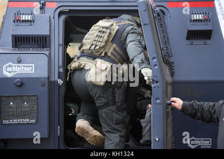 Des officiers de l'équipe SWAT embarquent à bord d'un nouveau véhicule blindé de protection spéciale de la police de Brandebourg sur le terrain du quartier général de la police à Potsdam (Allemagne), le 10 novembre 2017. Le véhicule coûte 1,4 millions d'euros et sera stationné à Potsdam. Le véhicule de la classe HMV Survivor est conçu pour une utilisation sur route et hors route, répond à des exigences de sécurité élevées contre les menaces balistiques et est donc résistant aux attaques par des fusils d'assaut. Photo : Ralf Hirschberger/dpa Banque D'Images