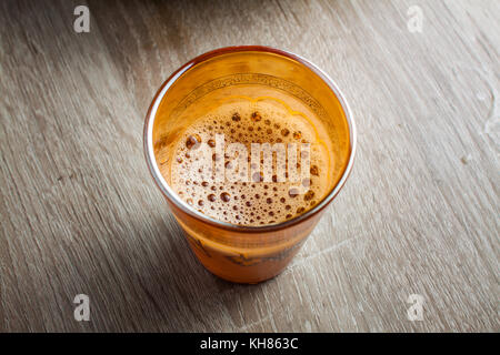 Close up d'un verre de thé marocain sur une table en bois Banque D'Images