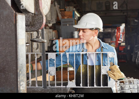 Woman in foundry comme travailleur avec moule en métal Banque D'Images