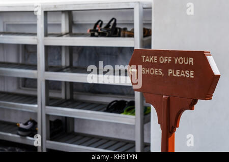 Enlevez vos chaussures veuillez signer en langue anglaise. Banque D'Images