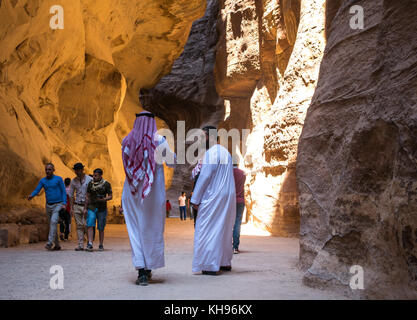 Deux hommes arabes traditionnelles en robes blanches, jubbahs, coiffure et marche à travers le siq gorge, Petra, Jordanie, Moyen-Orient, Banque D'Images