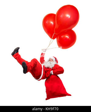 Drôle de père noël volant tombe avec un sac rempli de cadeaux. x-mas santa baisse air détient ballons isolé sur fond blanc. Le père noël passez avec ba Banque D'Images