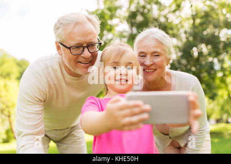 Les cadres supérieurs des grands-parents et petite-fille selfies Banque D'Images