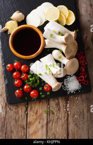 Pleurotes frais crus et les légumes, les épices et la sauce soja close-up sur la table. vertical haut Vue de dessus Banque D'Images