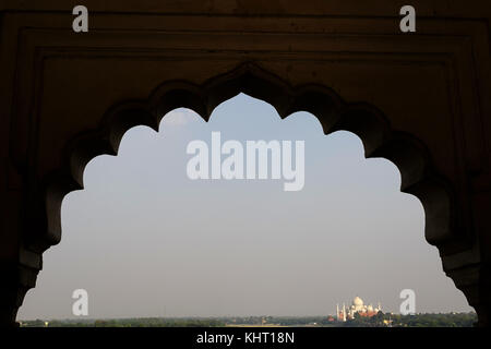 View of Taj Mahal à travers une fenêtre ornée arche à Fort rouge, encadré et de l'espace négatif autour de lui. Agra, Uttar Pradesh, Inde. Banque D'Images