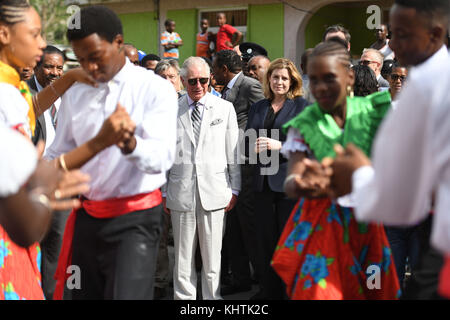 Le Prince de Galles, avec le Secrétaire au développement international Penny Mordtante, regardant des danseurs avant de rencontrer des habitants du village de Pichelin en République dominicaine, alors qu'il poursuit sa tournée des îles des Caraïbes ravagées par les ouragans. Banque D'Images