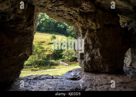 À la recherche d'une grotte à Beresford dale près de Hartington, Peak District, en Angleterre. Banque D'Images