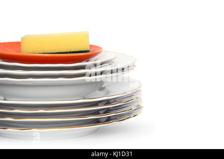 Éponge baignoire couchée sur pile de nettoyer les assiettes. Isolated on white with clipping path Banque D'Images