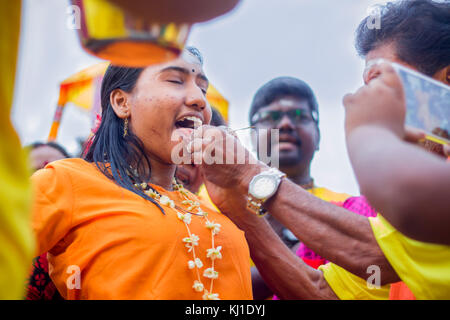 Pendant Thaipusam festival en Malaisie, les dévots hindous préparation cérémonie de bénédiction de la prière en langue piercing pour s'acquitter de leurs vœux et offrir grâce à Banque D'Images