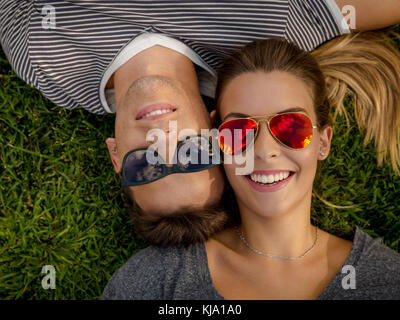 Portrait d'un jeune beau couple lying on the grass Banque D'Images