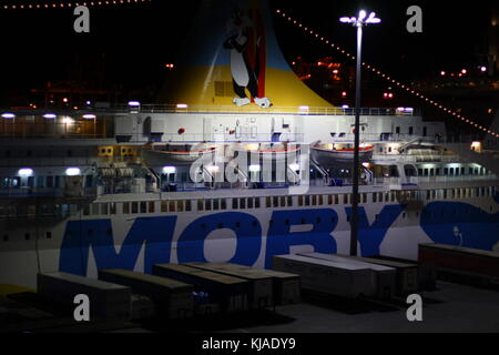 Un ferry géant moby lignes dans le port de Gênes, en Italie, la nuit, prêt à mettre les voiles vers l'eau de mer libre. Banque D'Images