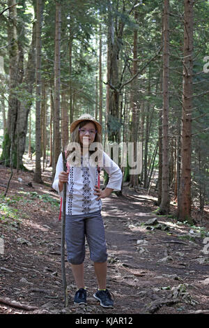 Petite fille randonneur en forêt Banque D'Images