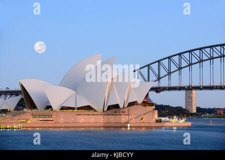 Image de la pleine lune super brillant juste avant le lever du soleil sur l'Opéra de Sydney à Sydney, en Australie, comme il a été vu à partir de la chaise de Mme Macquarie Banque D'Images