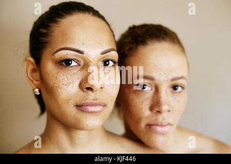 Close up of serious mixed race women Banque D'Images