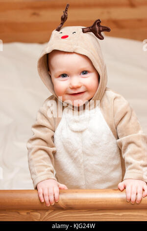 Little baby girl wearing costume deer looking at camera smiling Banque D'Images