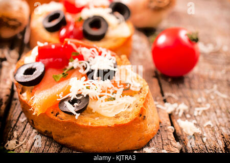 Bruschetta maison unique avec le saumon et le fromage feta sur table en bois Banque D'Images