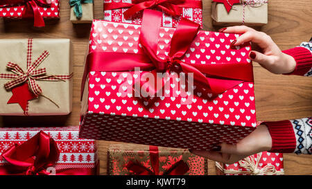 Femme tenant joliment emballé vintage cadeau de Noël, les mains détail. Noël bannière web Vue d'en haut Banque D'Images