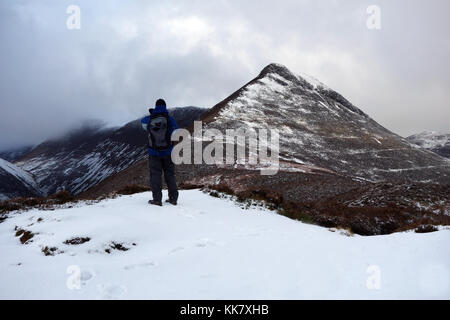 Homme seul dans fellwaker sur neige haut de Rowling fin sur la route de la montagne wainwright causey pike dans le parc national du Lake District, Cumbria.uk. Banque D'Images