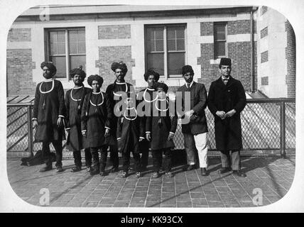 Une photographie d'un groupe d'immigrants qui sont arrivés sur l'île d'Ellis, la majorité du groupe sont porter, robe-comme tops et turbans, les deux hommes sur le droit porter un manteau et fezzes, New York, 1907. À partir de la Bibliothèque publique de New York. Banque D'Images