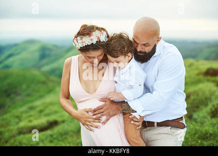 Jeune famille attente nouveau bébé. famille tenir la main sur le ventre de femme enceinte Banque D'Images