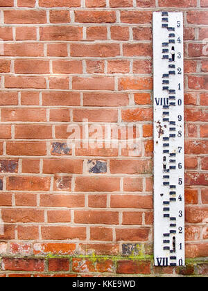 L'indicateur de niveau d'inondation sur le mur de brique Banque D'Images