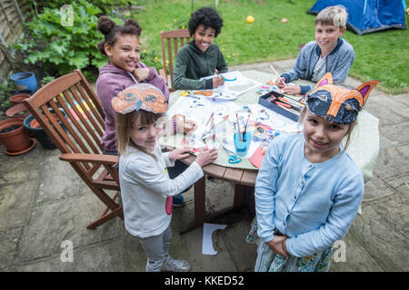 Événement sleepout big wild pix . Des images de jeunes enfants/ les enfants et les parents dans leur jardin à l'arrière du milieu de l'après-midi jusqu'à la nuit, profitent d'activités, par exemple, la fabrication d'un den, à la recherche de bugs, publiant de la nourriture pour chiens pour les hérissons, faire griller des guimauves autour d'un feu de camp, espèce de piégeage, à la recherche de la faune nocturne. Banque D'Images