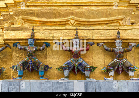 Bangkok, Thaïlande. Yakshas (démons) appuyant la chedi doré, Grand Palais Royal composé. Banque D'Images