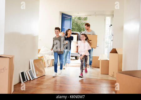 Avec des boîtes de la famille dans la nouvelle maison le jour du déménagement Banque D'Images