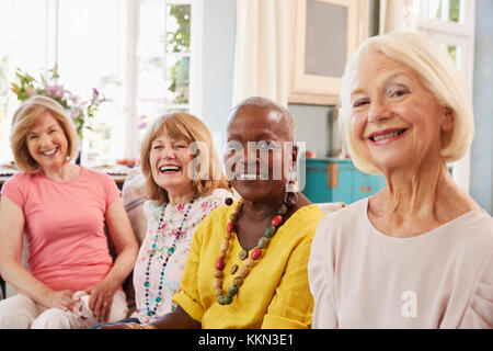 Portrait of Senior Woman Relaxing On Sofa At Home Banque D'Images