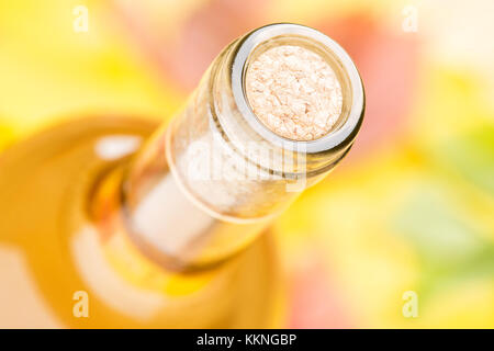 Une bouteille de vin blanc. Vue d'en haut. Dans un contexte de multi-couleur feuilles d'automne dans un flou artistique. Banque D'Images