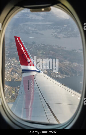 Bergen, Norvège - Octobre 2017 : norvégien avion winglet vu de l'intérieur avec la ville de Bergen, Norvège ci-dessous Banque D'Images