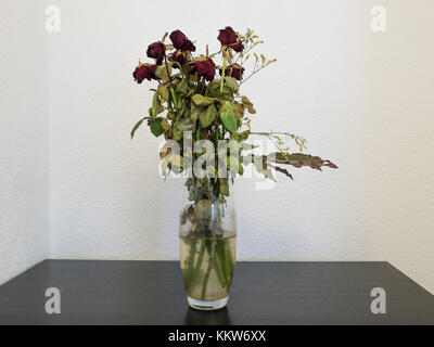 Withered bouquet de fleurs dans un vase en verre Banque D'Images